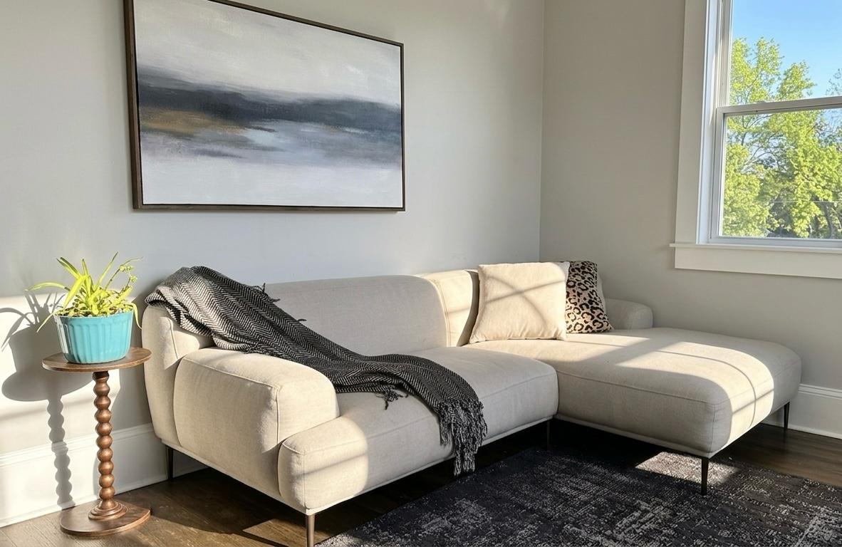 Living room with cream sectional and art